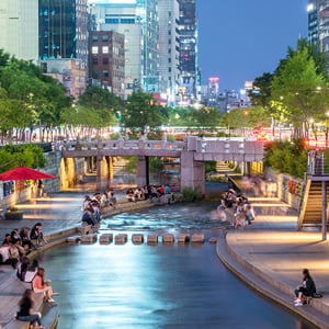 People relaxing by Cheong-Gyecheon stream in the centre of Seoul.