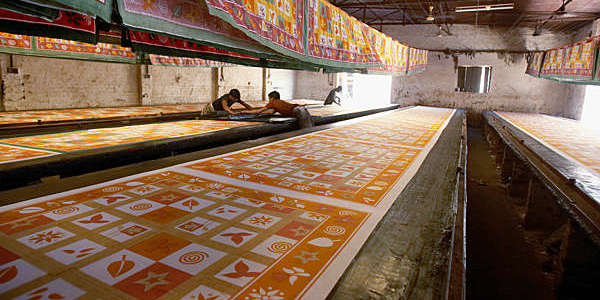 Workers making silk screen-printed textiles in Sanganer, India.