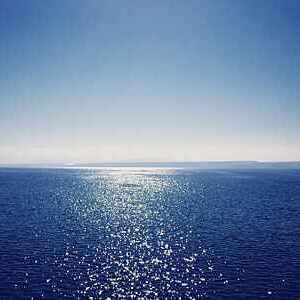 Sparkling sea under a clear blue sky.