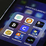 PARIS, FRANCE - FEBRUARY 26: In this photo illustration, the Coinbase cryptocurrency exchange logo (C) is seen on the screen of an iPhone on February 26, 2021 in Paris, France. Cryptocurrency trading platform Coinbase has filed for registration with the SEC on Thursday for an IPO via direct listing on the Nasdaq and will likely be the largest IPO of the year. Coinbase reported $ 1.28 billion in revenue in 2020 (+ 140% year on year), for net profit of $ 320 million. (Photo illustration by Chesnot/Getty Images)